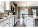 Galley kitchen featuring white cabinets, stainless steel appliances, and grey walls at 16126 Etna Green, Westfield, IN 46074