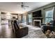 Open living room with fireplace, seamlessly connecting to the dining area and kitchen, providing ample space at 16126 Etna Green, Westfield, IN 46074