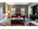 Cozy living room with a red sofa, decorative accents, hardwood floors, and ample natural light at 16126 Etna Green, Westfield, IN 46074