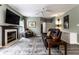 Inviting living room features a fireplace, large TV, and comfortable seating on top of a large area rug at 16126 Etna Green, Westfield, IN 46074