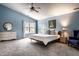 Spacious main bedroom with blue walls, ceiling fan, walk-in closet, large window, and carpeted floors at 16126 Etna Green, Westfield, IN 46074