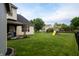 This backyard includes a large manicured lawn, playground and covered patio for entertaining at 1713 Williamsburg Cir, Franklin, IN 46131