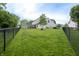 This backyard includes a black metal fence, maintained lawn and shed with mature trees at 1713 Williamsburg Cir, Franklin, IN 46131