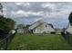 Large backyard with a small shed and a black chain link fence at 1713 Williamsburg Cir, Franklin, IN 46131