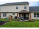 This backyard features a patio under a gazebo with a grill and green grass at 1713 Williamsburg Cir, Franklin, IN 46131