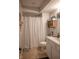 Clean bathroom with neutral decor, shower with patterned curtain, and white vanity at 1713 Williamsburg Cir, Franklin, IN 46131