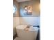 Modern bathtub featuring white subway tile, sleek black fixtures, a wooden bath tray, and a charming pig art print at 1713 Williamsburg Cir, Franklin, IN 46131