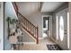 Inviting entryway featuring a staircase, neutral walls, decorative table, and a view into other rooms of the home at 1713 Williamsburg Cir, Franklin, IN 46131