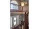 The foyer features a decorative front door, hardwood stairs and floors and a window above at 1713 Williamsburg Cir, Franklin, IN 46131