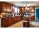 Well-equipped kitchen with dark wood cabinets, granite countertops, and stainless steel appliances at 1713 Williamsburg Cir, Franklin, IN 46131