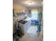 This laundry room includes front load washer/dryer, window, overhead shelving, and neutral paint at 1713 Williamsburg Cir, Franklin, IN 46131