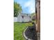 This backyard shed has cottage style doors with flower planters near the entrance at 1713 Williamsburg Cir, Franklin, IN 46131