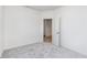 Empty bedroom with light gray carpet, white trim, and a door to an adjoining space at 18967 Seaforth Way, Westfield, IN 46074