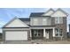 Charming two-story home featuring brick, white trim, gray siding, and an attached two car garage at 18967 Seaforth Way, Westfield, IN 46074