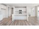 Bright kitchen featuring a center island, white cabinetry, and stainless steel microwave at 18967 Seaforth Way, Westfield, IN 46074