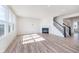 Open living room with fireplace, staircase, and large windows bringing in natural light at 18967 Seaforth Way, Westfield, IN 46074