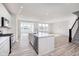 Bright, open-concept living room featuring a kitchen island, and light-filled dining area at 18967 Seaforth Way, Westfield, IN 46074