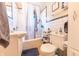 Bright bathroom featuring a tiled shower and tub, a classic pedestal sink, and tiled walls at 1913 Pennsylvania St, Columbus, IN 47201