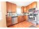 Well-lit kitchen with stainless steel appliances, wooden cabinets, and ample counter space for cooking at 1913 Pennsylvania St, Columbus, IN 47201