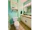 Bathroom with a toilet, sink, vanity with storage, and decorative mirror at 199 Fountain Lake S Dr, Shelbyville, IN 46176