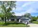 Charming single-Gathering home featuring an attached garage and well-maintained front lawn at 199 Fountain Lake S Dr, Shelbyville, IN 46176