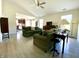 Bright living room with high ceilings, a ceiling fan, and a view into the kitchen at 199 Fountain Lake S Dr, Shelbyville, IN 46176