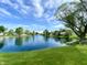 Beautiful lake with lush green grass and foliage surrounding it at 199 Fountain Lake S Dr, Shelbyville, IN 46176