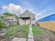 Exterior rear of home has an elevated deck with access via a steel security door at 2006 N Olney St, Indianapolis, IN 46218