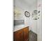 Outdated bathroom with a vanity and mirror on the wall at 2006 N Olney St, Indianapolis, IN 46218