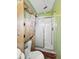 Bathroom features a stand-up shower, commode, and light green walls at 2006 N Olney St, Indianapolis, IN 46218