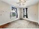 A bright bedroom featuring hardwood floors and a ceiling fan at 2006 N Olney St, Indianapolis, IN 46218