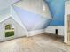 A room with blue paint and white walls with a window overlooking a tree-filled lawn at 2006 N Olney St, Indianapolis, IN 46218