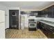 A dated kitchen with a gas stove and access to a water heater at 2006 N Olney St, Indianapolis, IN 46218