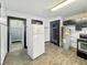Kitchen with a dated refrigerator and water heater at 2006 N Olney St, Indianapolis, IN 46218