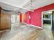 Open-concept living room featuring a ceiling fan, hardwood floors, and multiple access points at 2006 N Olney St, Indianapolis, IN 46218