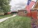This backyard features a well-maintained lawn, charming brick accents, a walkway, and a privacy fence at 2010 Alexandria Dr, Greenfield, IN 46140