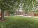 Spacious backyard with a covered sunroom and a patio area for outdoor entertaining at 2010 Alexandria Dr, Greenfield, IN 46140