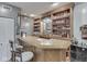 Home bar featuring custom wood cabinetry and ample storage for beverages and glassware at 2010 Alexandria Dr, Greenfield, IN 46140
