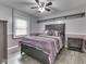 Bedroom with a ceiling fan, hardwood floors, large bed, and natural light at 2010 Alexandria Dr, Greenfield, IN 46140