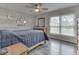 Cozy bedroom with wood-look flooring, a decorative wall, and a comfortable bed with blue quilt at 2010 Alexandria Dr, Greenfield, IN 46140