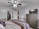 Bedroom with a ceiling fan, hardwood floors, large bed, dresser, and closet at 2010 Alexandria Dr, Greenfield, IN 46140