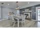 Dining room with a fireplace, modern light fixture, and a decorative wall creating a cozy space at 2010 Alexandria Dr, Greenfield, IN 46140