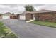 View of the home's driveway, detached garage, and brick exterior at 2010 Alexandria Dr, Greenfield, IN 46140