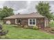 Beautiful brick home with well-maintained landscaping and mature trees in a serene setting at 2010 Alexandria Dr, Greenfield, IN 46140