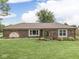 Charming brick home featuring a well-manicured lawn and inviting landscape elements at 2010 Alexandria Dr, Greenfield, IN 46140
