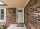Exterior of front door showing sidelight, welcome mat and brick siding at 2010 Alexandria Dr, Greenfield, IN 46140