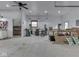 Spacious garage with work area, ceiling fan, bright lighting, and ample room for projects at 2010 Alexandria Dr, Greenfield, IN 46140