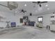 Spacious garage with a refrigerator, work benches, a TV, storage, and many electrical outlets at 2010 Alexandria Dr, Greenfield, IN 46140
