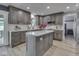 Well-lit kitchen featuring gray cabinetry, marble countertops and a center island with breakfast bar at 2010 Alexandria Dr, Greenfield, IN 46140