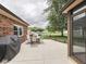 View of home's concrete patio with a grill, outdoor dining set, and a view of a large backyard at 2010 Alexandria Dr, Greenfield, IN 46140
